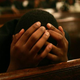 A man bows his head in prayer during Easter service in Harlem.
Mario Tama/Getty Images